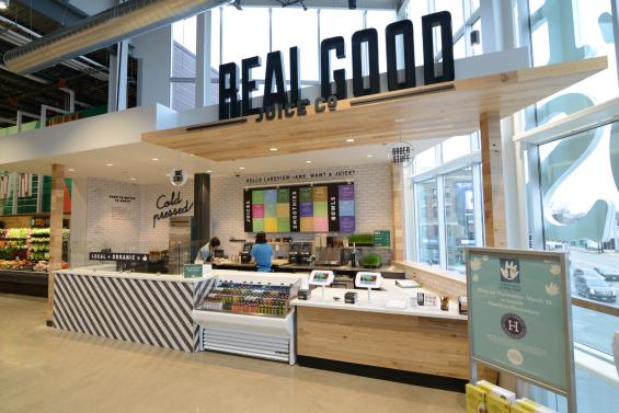This juice shop within Whole Foods uses American Gothic Mixed Hardwoods reclaimed paneling wrapped around the counter and ceiling. 