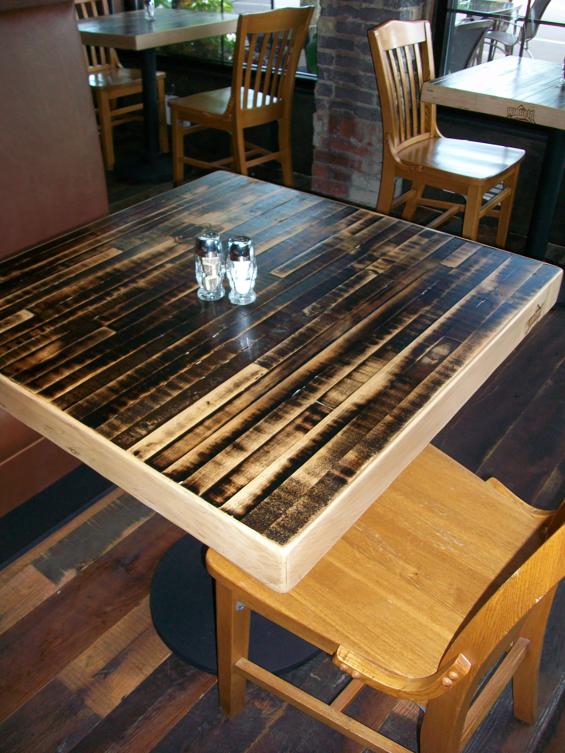 The underside of reclaimed bowling alley lanes reveals a unique black patina.