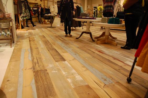 A custom mixture of American Prairie reclaimed softwoods (barn wood) was gently planed to keep some of the paint intact for this custom wide plank floor.