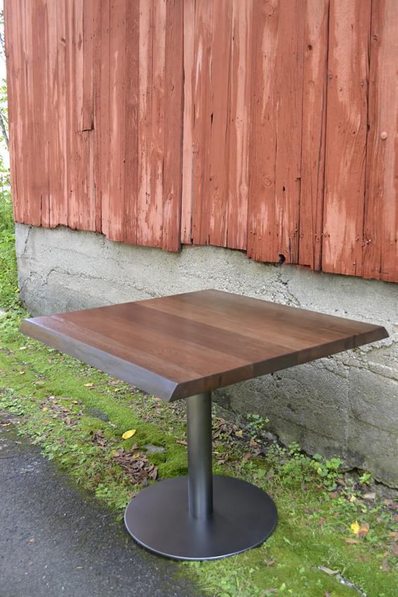 A live edge adds a bit of character to a dark four top table.