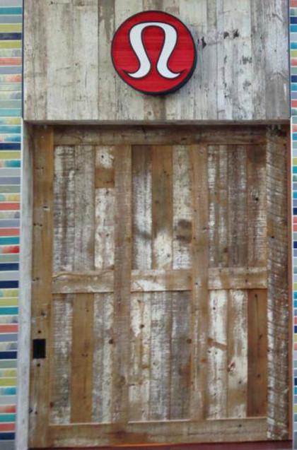 Custom finished reclaimed softwoods adorn a store exterior.