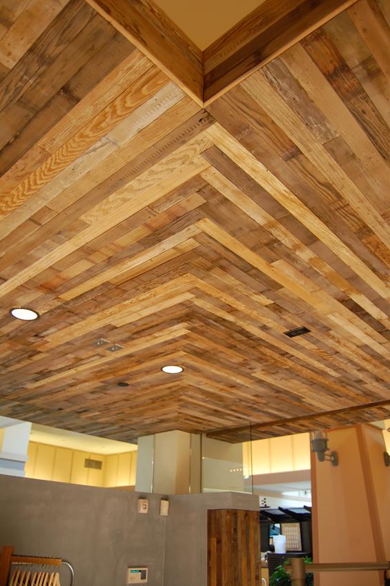 Reclaimed from pickle vats, narrow wood stock is shown here as the ceiling accent.