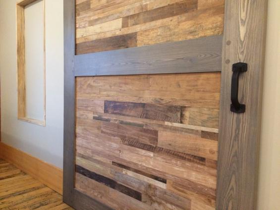 Reclaimed teak patina panels join custom finished American Gothic oak on an office lobby door.