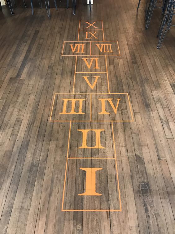 Its all fun and games, as patrons are greeted with a hopscotch board painted on the reclaimed gym flooring when you enter Clinton Hall in New York City.