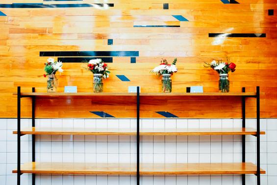 Original gym flooring arranged in a confetti pattern at the Madison Ave. location of Minigrown in New York City. Photo by Kyle Huff.