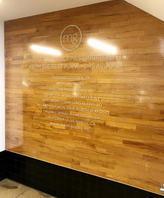 Original gym flooring reclaimed wood used as paneling in the 7th Ave. location of Minigrow in New York City