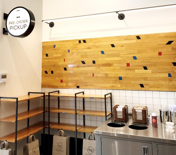 Original gym flooring arranged in a confetti pattern in the 7th Ave. location of Minigrown in New York City.