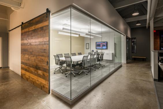 8'x8' flat track door for an office conference room using Pioneer Millworks Settlers' Plank Mixed Hardwoods