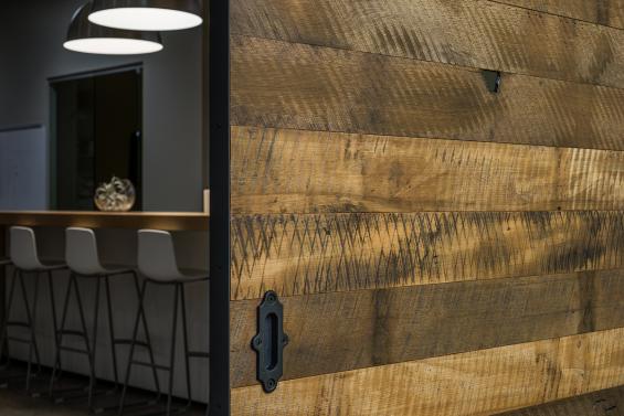 8'x8' flat track door for an office conference room using Pioneer Millworks Settlers' Plank Mixed Hardwoods