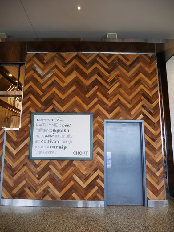 Mixed hardwoods settlers plank reclaimed wall paneling at Chopt in New York City.