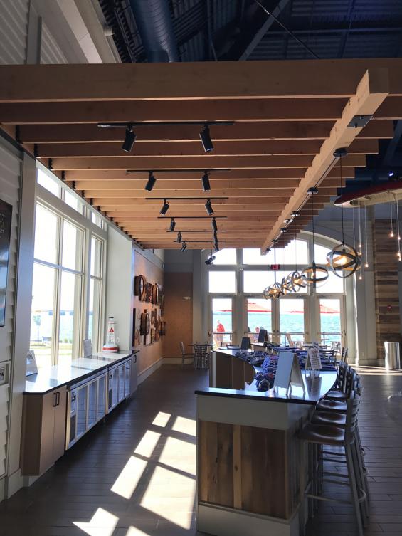 Pioneer Millworks fresh sawn Douglas fir timbers create a trellis over the bar area.