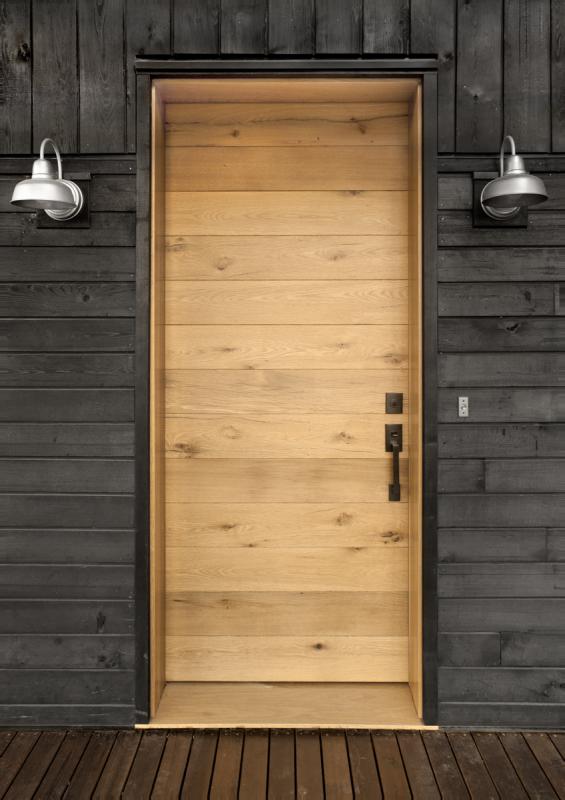 Larch Deep Char exterior paneling paired with an American Gothic Mixed Oak reclaimed wood door. Photo by Loren Nelson.