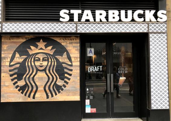 Starbucks logo painted on Settlers' Plank Mixed Oak paneling.