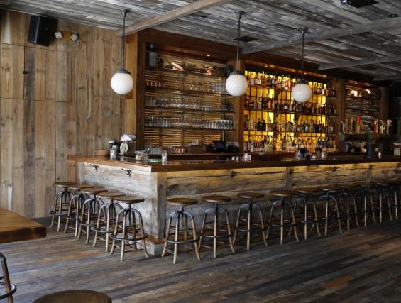asdfReclaimed Foundry Maple Floor, River Skins, and Mushroom Boards combine textures and tones for the main bar area in The Barrow House.