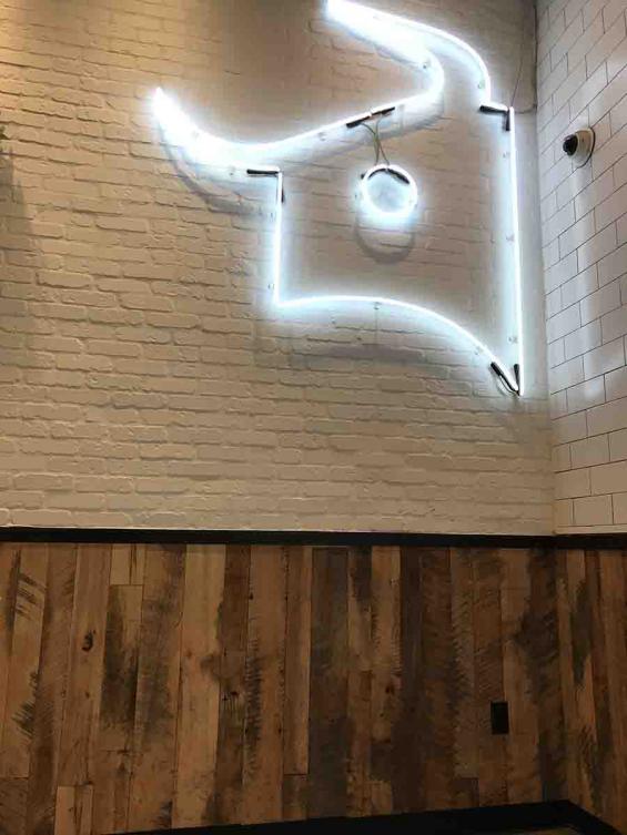 Close up of our Mixed Hardwoods Settlers' Plank reclaimed wood paneling at Dos Toros Taqueria in New York City