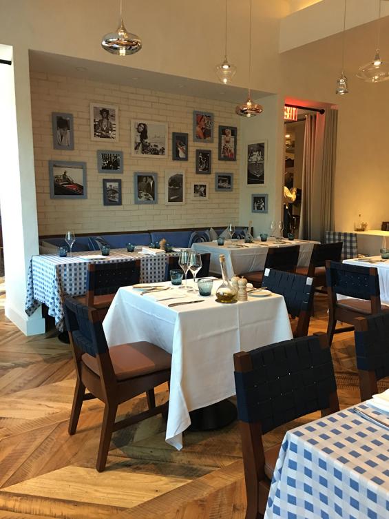 Pioneer Millworks reclaimed Settlers' Plank Mixed Hardwoods in Dolce Riviera restaurant in Dallas, Texas. Installed in a chevron pattern.