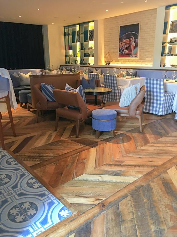 Pioneer Millworks reclaimed Settlers' Plank Mixed Hardwoods in Dolce Riviera restaurant in Dallas, Texas. Installed in a chevron pattern.