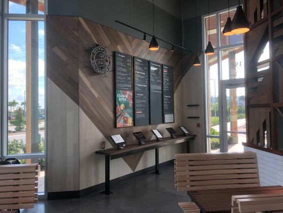 Pioneer Millworks Modern Farmhouse Walnut and Modern Farmhouse Ash with Poly finish and Fire Retardant in Shake Shack Sarasota, FL.