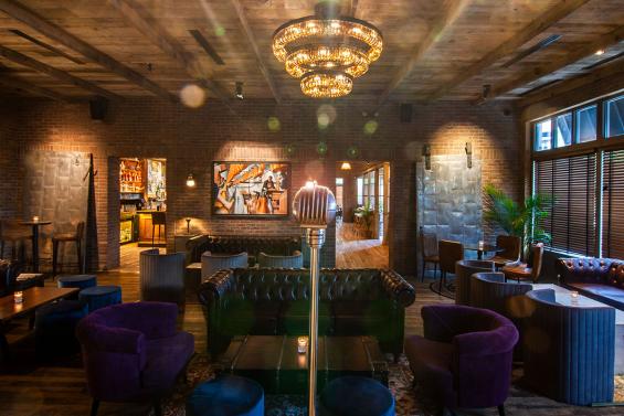 Pioneer Millworks Foundry Maple floor and original white pane floor joists on the ceiling. 