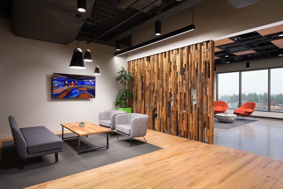 American Gothic white oak reclaimed flooring flows through this Bellevue office and is met with a slat wall created from as found Douglas Fir joists with skip planed patina. (c) Clearly O'Farrell Photography.