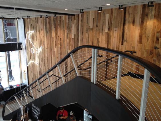 Settlers Plank mixed hardwoods reclaimed wood paneling leads customers up to the second floor of this Dos Toros Taqueria in Chicago, IL.
