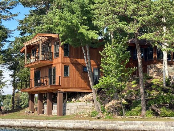 Private Residence on Alexandria Bay with Select Larch Exterior Siding wire brushed with a Light Brown non-VOC water-based penetrating sealer.