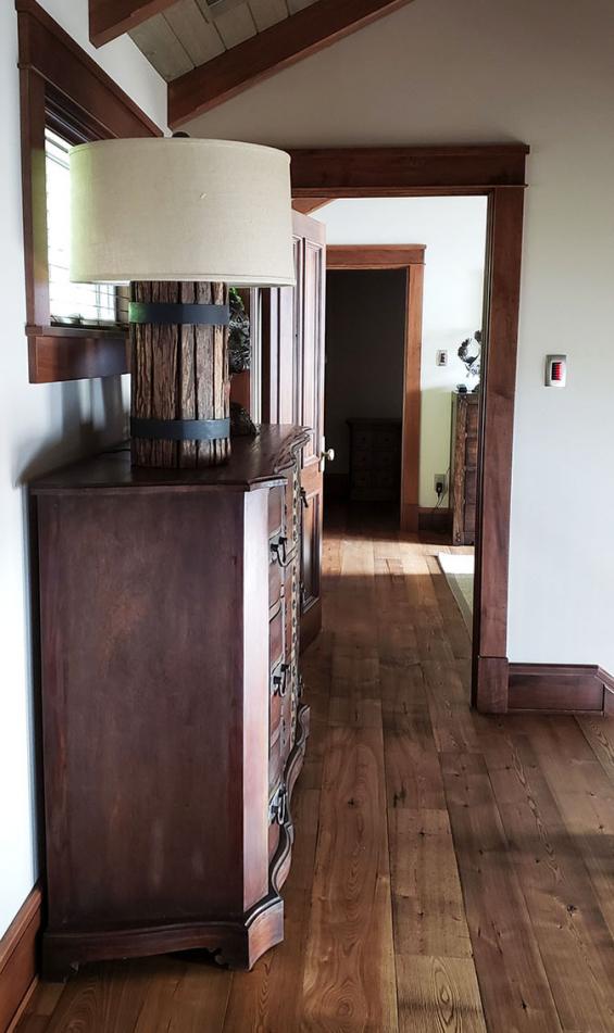 Pioneer Millworks American Gothic Ash flooring with a Castle Brown finish applied.