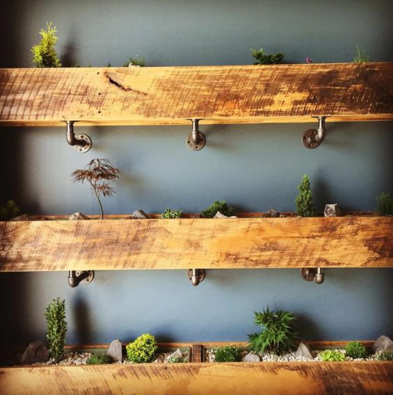 Planter boxes fashioned from leftover reclaimed hardwoods welcome patrons in the Kindred Fare entryway.