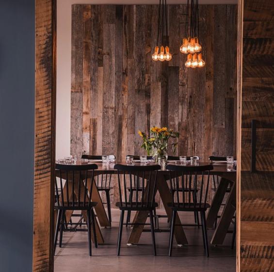 NEWwoodworks "V" base tables are often paired to create more community style seating in the special occasion dining area at Kindred Fare.