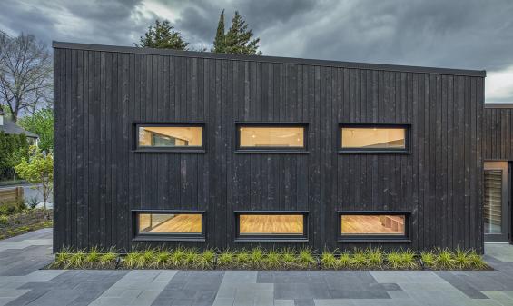 Shou Sugi Ban Larch Carbon by Pioneer Millworks. Black wood siding that is burned. Here seen as Exterior Siding at the Portland Playhouse in Portland, OR