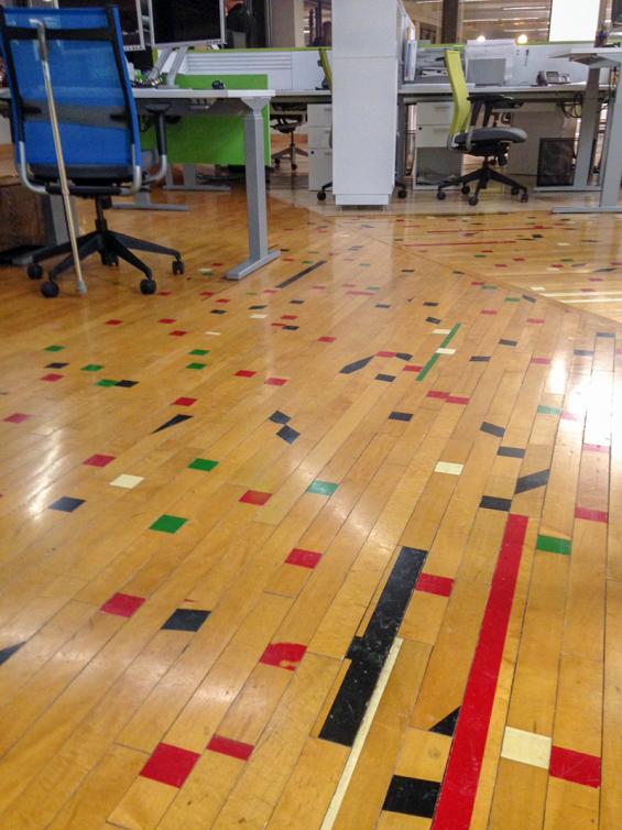 Pioneer Millworks reclaimed gym floor in "confetti" pattern.